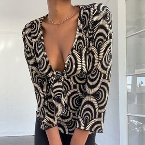 Chic top with tie in front and tie in back.